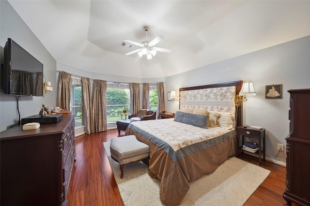 7410 Fall Creek Bnd, Humble, TX 77396 - bedroom featuring dark wood finished floors, lofted ceiling, ceiling fan, and baseboards