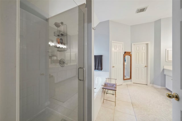 7410 Fall Creek Bnd, Humble, TX 77396 - full bathroom featuring a stall shower, a bath, tile patterned flooring, vanity, and baseboards