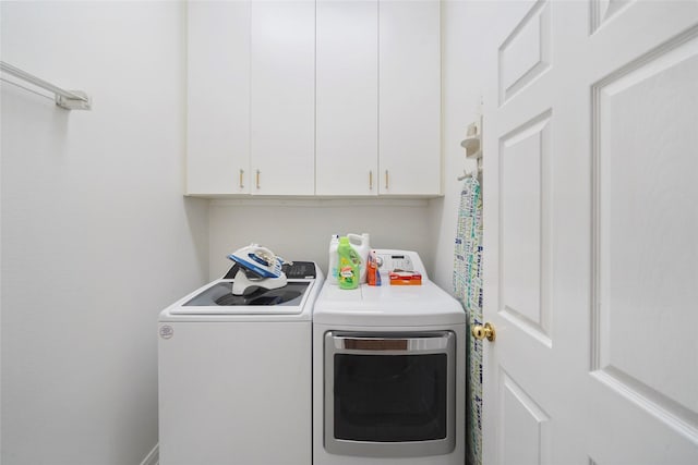 7410 Fall Creek Bnd, Humble, TX 77396 - laundry room with washing machine and dryer and cabinet space