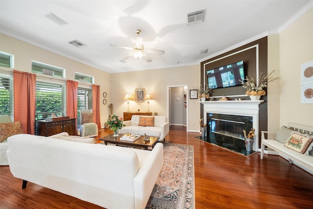 7410 Fall Creek Bnd, Humble, TX 77396 - living area featuring wood finished floors, a high end fireplace, ceiling fan, and crown molding