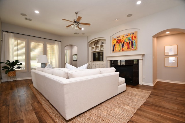 21006 Refuge Creek Dr, Cypress, TX 77433 - living room featuring arched walkways, hardwood / wood-style flooring, baseboards, ceiling fan, and recessed lighting