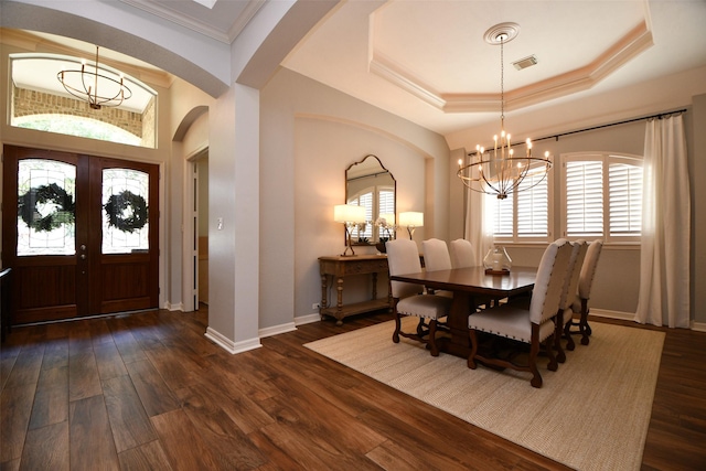21006 Refuge Creek Dr, Cypress, TX 77433 - foyer entrance featuring a chandelier, arched walkways, dark wood-style flooring, baseboards, and crown molding