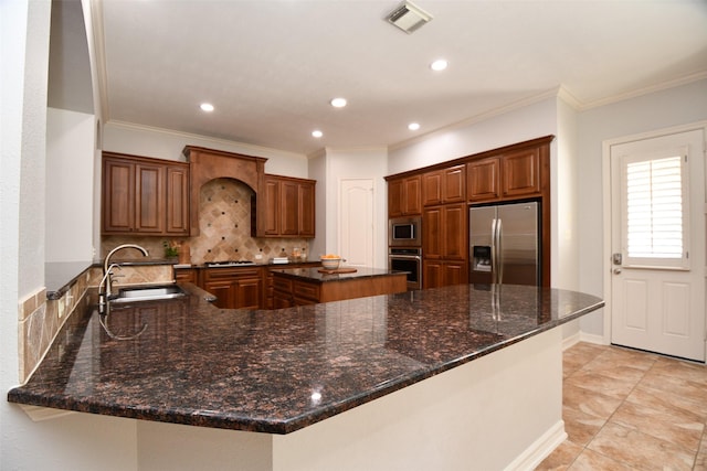 21006 Refuge Creek Dr, Cypress, TX 77433 - kitchen featuring stainless steel appliances, a sink, decorative backsplash, ornamental molding, and a center island
