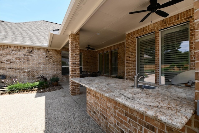 21006 Refuge Creek Dr, Cypress, TX 77433 - view of patio with a ceiling fan, a sink, and an outdoor kitchen