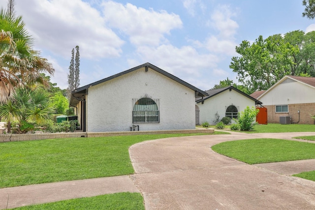 6003 Green Falls Dr, Houston, TX 77088 - view of front of home with cooling unit, stucco siding, and a front lawn