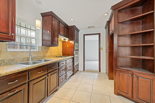 6003 Green Falls Dr, Houston, TX 77088 - kitchen with appliances with stainless steel finishes, a sink, pendant lighting, tasteful backsplash, and recessed lighting