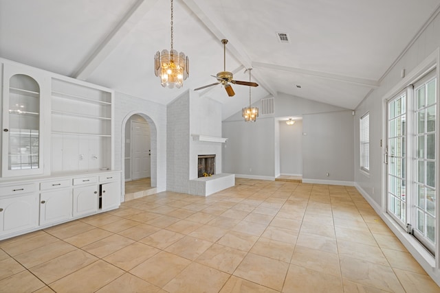 6003 Green Falls Dr, Houston, TX 77088 - unfurnished living room featuring a ceiling fan, a fireplace, arched walkways, light tile patterned floors, and built in features