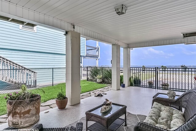 1309 Blue Heron St, Bayou Vista, TX 77563 - fenced backyard with a patio, an outdoor living space, and a water view