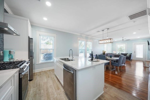 4702 Avenue N 1/2 Avenue, Galveston, TX 77551 - kitchen with a sink, appliances with stainless steel finishes, open floor plan, light wood finished floors, and plenty of natural light