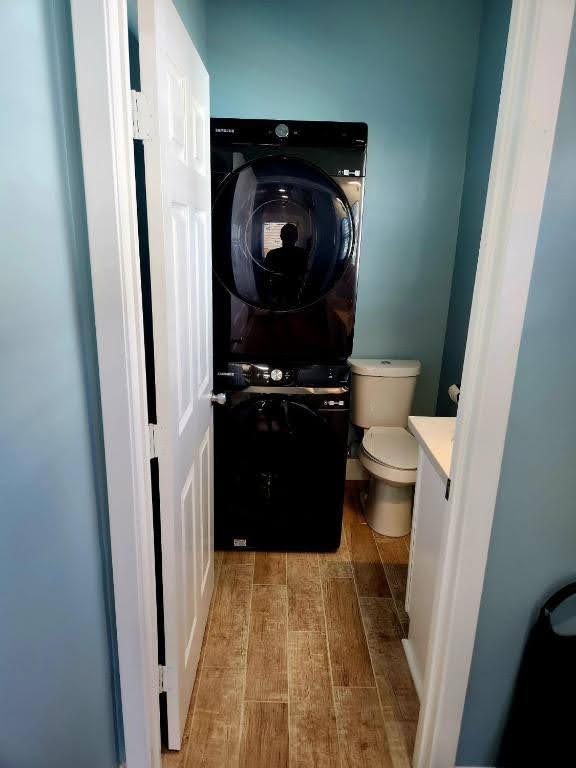 4702 Avenue N 1/2 Avenue, Galveston, TX 77551 - half bath featuring vanity, stacked washing machine and dryer, and toilet
