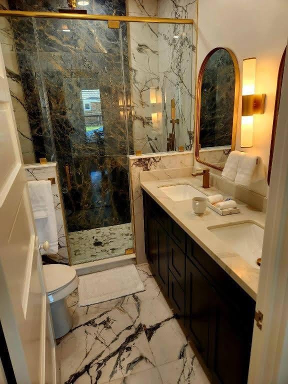 4702 Avenue N 1/2 Avenue, Galveston, TX 77551 - full bath with a marble finish shower, marble finish floors, double vanity, and toilet