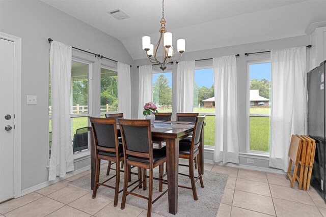 12 Oakland Ct, Huntsville, TX 77340 - dining room with a chandelier, vaulted ceiling, light tile patterned floors, and baseboards