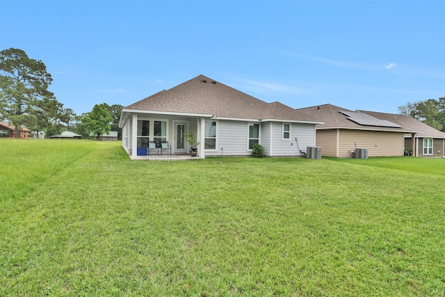 12 Oakland Ct, Huntsville, TX 77340 - rear view of property with central AC, a lawn, a shingled roof, and a sunroom