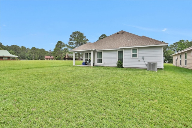 12 Oakland Ct, Huntsville, TX 77340 - rear view of property with central AC unit, a shingled roof, a lawn, and a patio