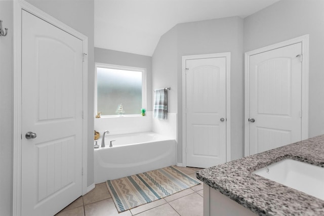 12 Oakland Ct, Huntsville, TX 77340 - full bathroom featuring vanity, a garden tub, tile patterned floors, and vaulted ceiling