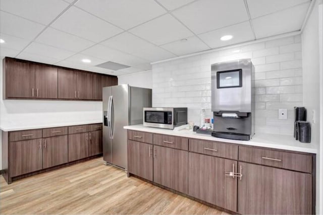 2016 Main St Unit 1505, Houston, TX 77002 - kitchen with stainless steel appliances, a drop ceiling, light countertops, light wood finished floors, and recessed lighting