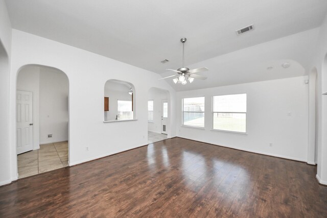 19130 Center Park Dr, Spring, TX 77373 - unfurnished living room featuring ceiling fan, wood finished floors, lofted ceiling, and arched walkways