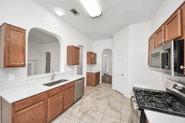 19130 Center Park Dr, Spring, TX 77373 - kitchen with stainless steel appliances, a sink, tasteful backsplash, and light countertops