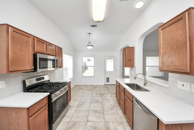 19130 Center Park Dr, Spring, TX 77373 - kitchen featuring stainless steel appliances, a sink, lofted ceiling, decorative backsplash, and light marble finish flooring