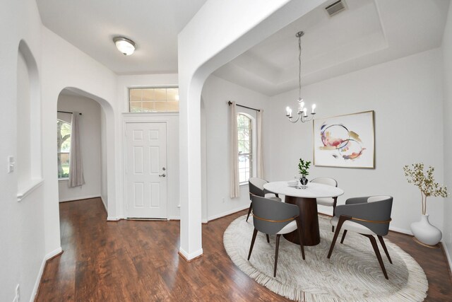 19130 Center Park Dr, Spring, TX 77373 - dining room with arched walkways, healthy amount of natural light, a chandelier, and dark wood-style floors