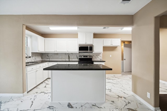 1904 Kansas St, Baytown, TX 77520 - kitchen with appliances with stainless steel finishes, baseboards, and light marble finish floors