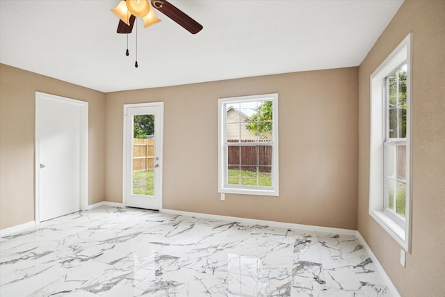 1904 Kansas St, Baytown, TX 77520 - spare room with baseboards, ceiling fan, and light marble finish floors