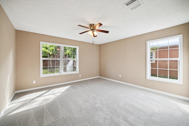 1904 Kansas St, Baytown, TX 77520 - unfurnished room with carpet floors, a ceiling fan, a textured ceiling, and baseboards