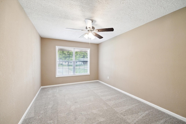 1904 Kansas St, Baytown, TX 77520 - empty room with a ceiling fan, carpet flooring, baseboards, and a textured ceiling