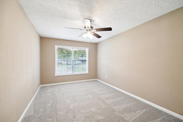 1904 Kansas St, Baytown, TX 77520 - empty room with ceiling fan, carpet floors, and a textured ceiling