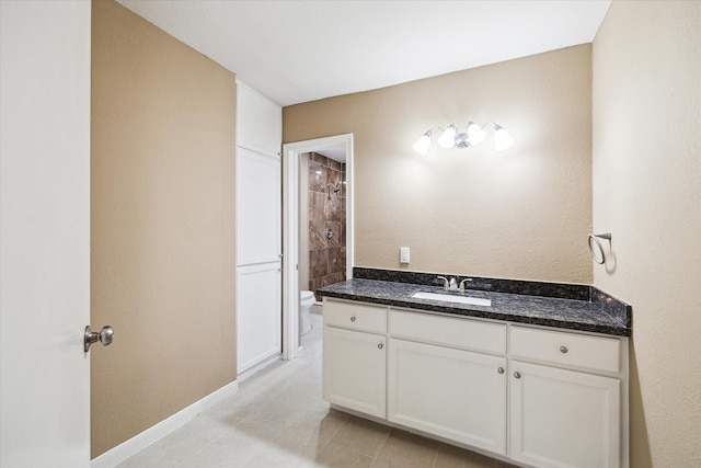 1904 Kansas St, Baytown, TX 77520 - bathroom with toilet, vanity, tile patterned flooring, a tile shower, and baseboards