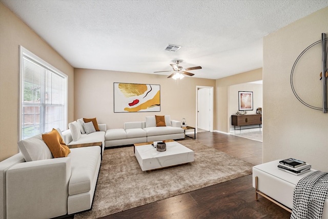 1904 Kansas St, Baytown, TX 77520 - living area with wood finished floors, a ceiling fan, and a textured ceiling