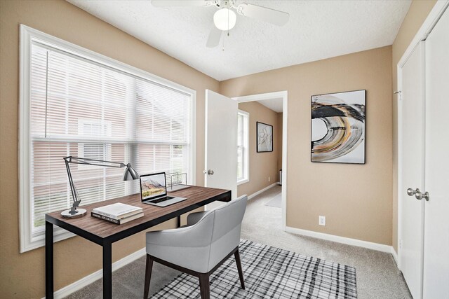 1904 Kansas St, Baytown, TX 77520 - home office with light carpet, ceiling fan, and a textured ceiling