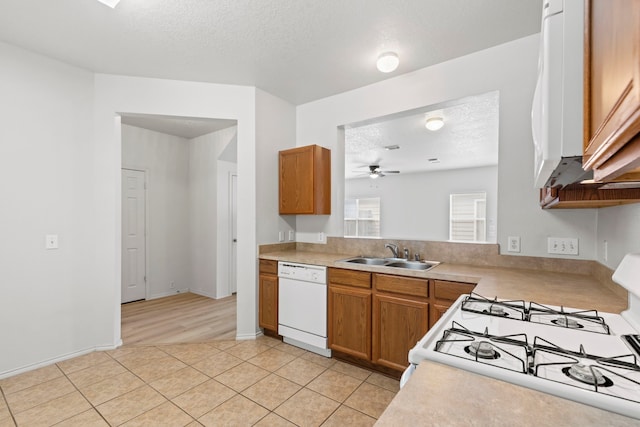 23831 Single Oak St, Spring, TX 77373 - kitchen featuring a sink, white appliances, light countertops, a ceiling fan, and a textured ceiling