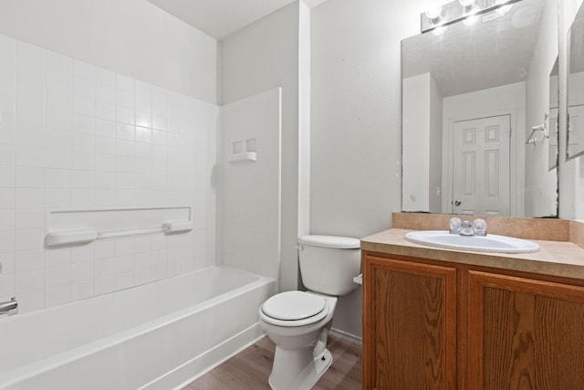23831 Single Oak St, Spring, TX 77373 - bathroom featuring toilet, wood finished floors, vanity, and shower / tub combination