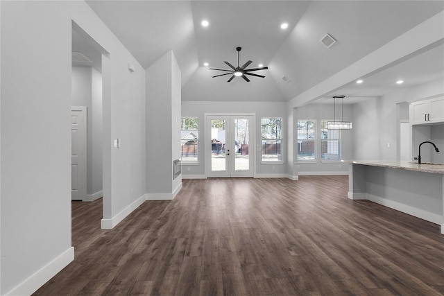 23826 Cow Oak Dr, Spring, TX 77389 - unfurnished living room featuring a sink, baseboards, healthy amount of natural light, high vaulted ceiling, and recessed lighting