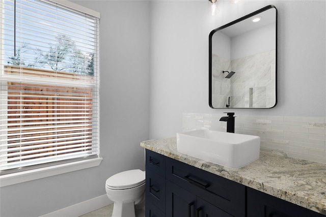 23826 Cow Oak Dr, Spring, TX 77389 - bathroom featuring decorative backsplash, toilet, a shower, vanity, and baseboards