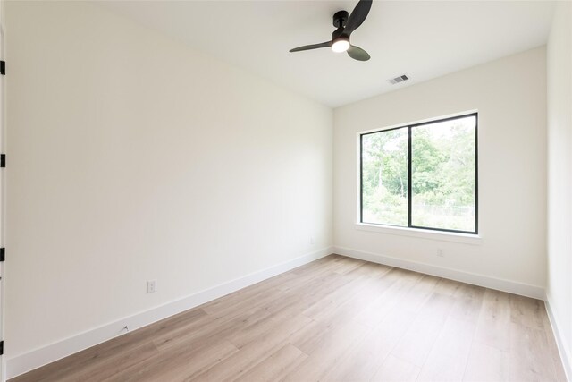 6135 Pacific Forest Dr, Houston, TX 77346 - spare room with light wood-style flooring, a ceiling fan, and baseboards