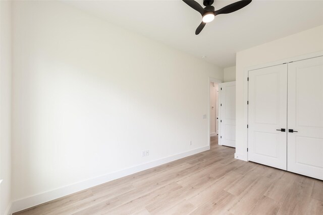 6135 Pacific Forest Dr, Houston, TX 77346 - unfurnished bedroom with light wood-style flooring, baseboards, a closet, and ceiling fan