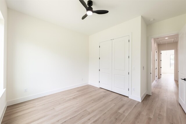 6135 Pacific Forest Dr, Houston, TX 77346 - unfurnished bedroom featuring attic access, light wood finished floors, a closet, baseboards, and ceiling fan