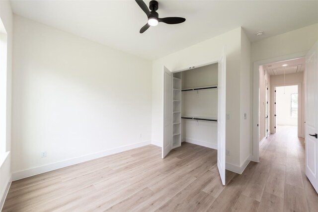 6135 Pacific Forest Dr, Houston, TX 77346 - unfurnished bedroom with attic access, light wood finished floors, a closet, and baseboards