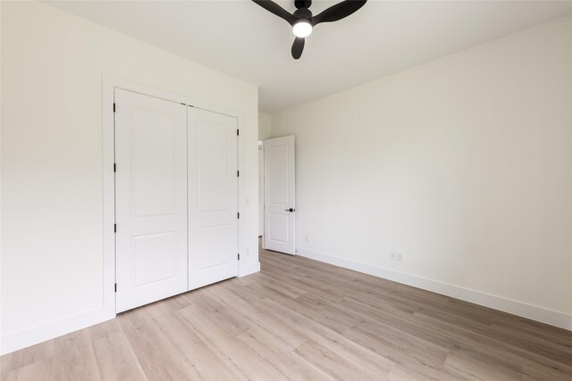 6135 Pacific Forest Dr, Houston, TX 77346 - unfurnished bedroom featuring light wood-type flooring, a closet, baseboards, and a ceiling fan