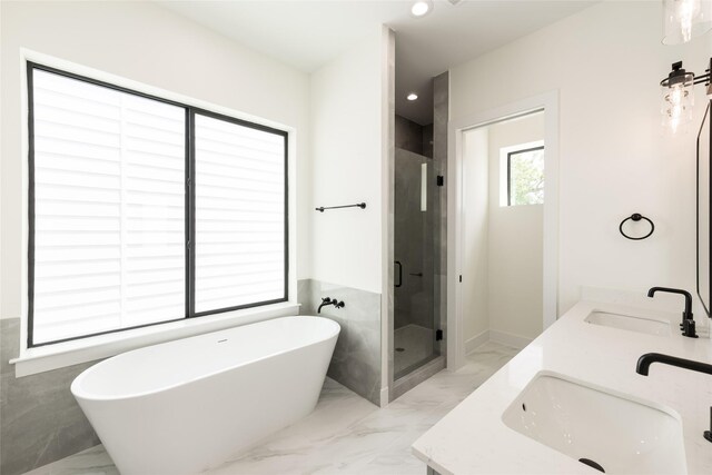 6135 Pacific Forest Dr, Houston, TX 77346 - full bath featuring marble tiled floors, a shower stall, a freestanding tub, double vanity, and recessed lighting