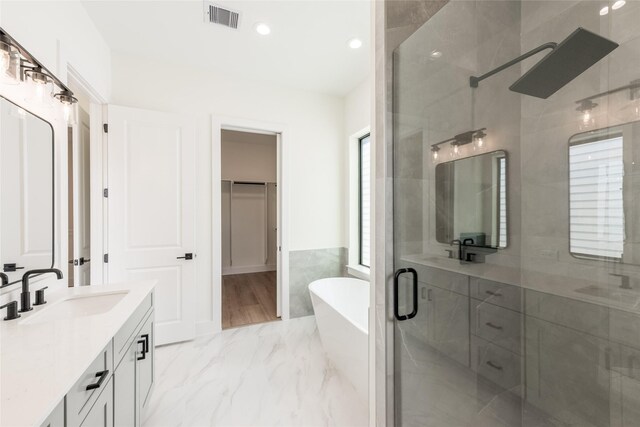 6135 Pacific Forest Dr, Houston, TX 77346 - bathroom featuring a stall shower, a soaking tub, vanity, marble finish flooring, and recessed lighting