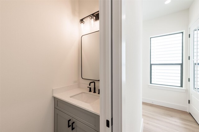 6135 Pacific Forest Dr, Houston, TX 77346 - bathroom with vanity, healthy amount of natural light, wood finished floors, baseboards, and recessed lighting