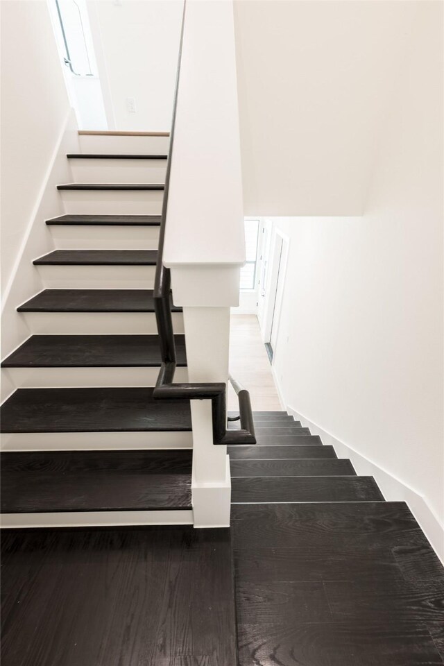 6135 Pacific Forest Dr, Houston, TX 77346 - staircase with wood finished floors and baseboards