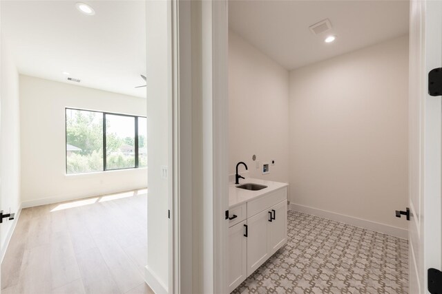 6135 Pacific Forest Dr, Houston, TX 77346 - laundry room featuring a sink, recessed lighting, baseboards, and light flooring
