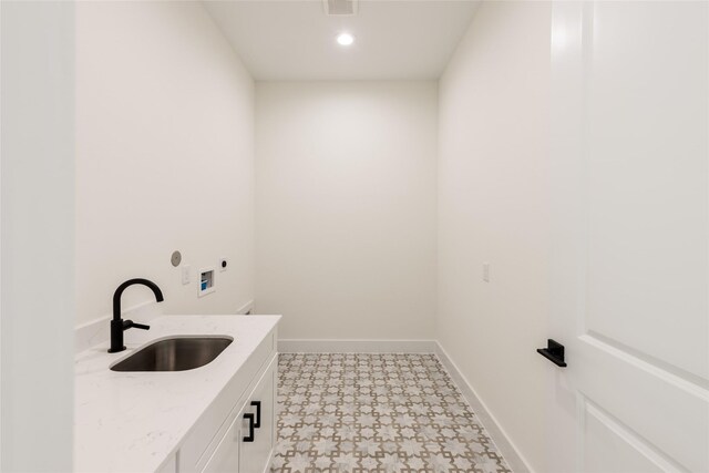 6135 Pacific Forest Dr, Houston, TX 77346 - laundry room with cabinet space, electric dryer hookup, hookup for a washing machine, tile patterned floors, and baseboards