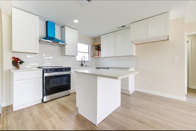51 Blue Bonnet Ct, Lake Jackson, TX 77566 - kitchen with range with electric stovetop, wall chimney exhaust hood, open shelves, a sink, and light wood-type flooring