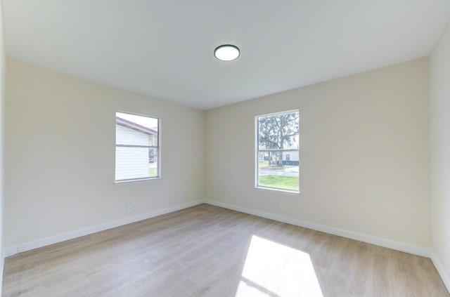 51 Blue Bonnet Ct, Lake Jackson, TX 77566 - unfurnished room with healthy amount of natural light, light wood finished floors, and baseboards