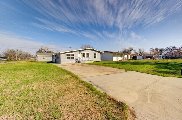 51 Blue Bonnet Ct, Lake Jackson, TX 77566 - rear view of property featuring concrete driveway and a yard
